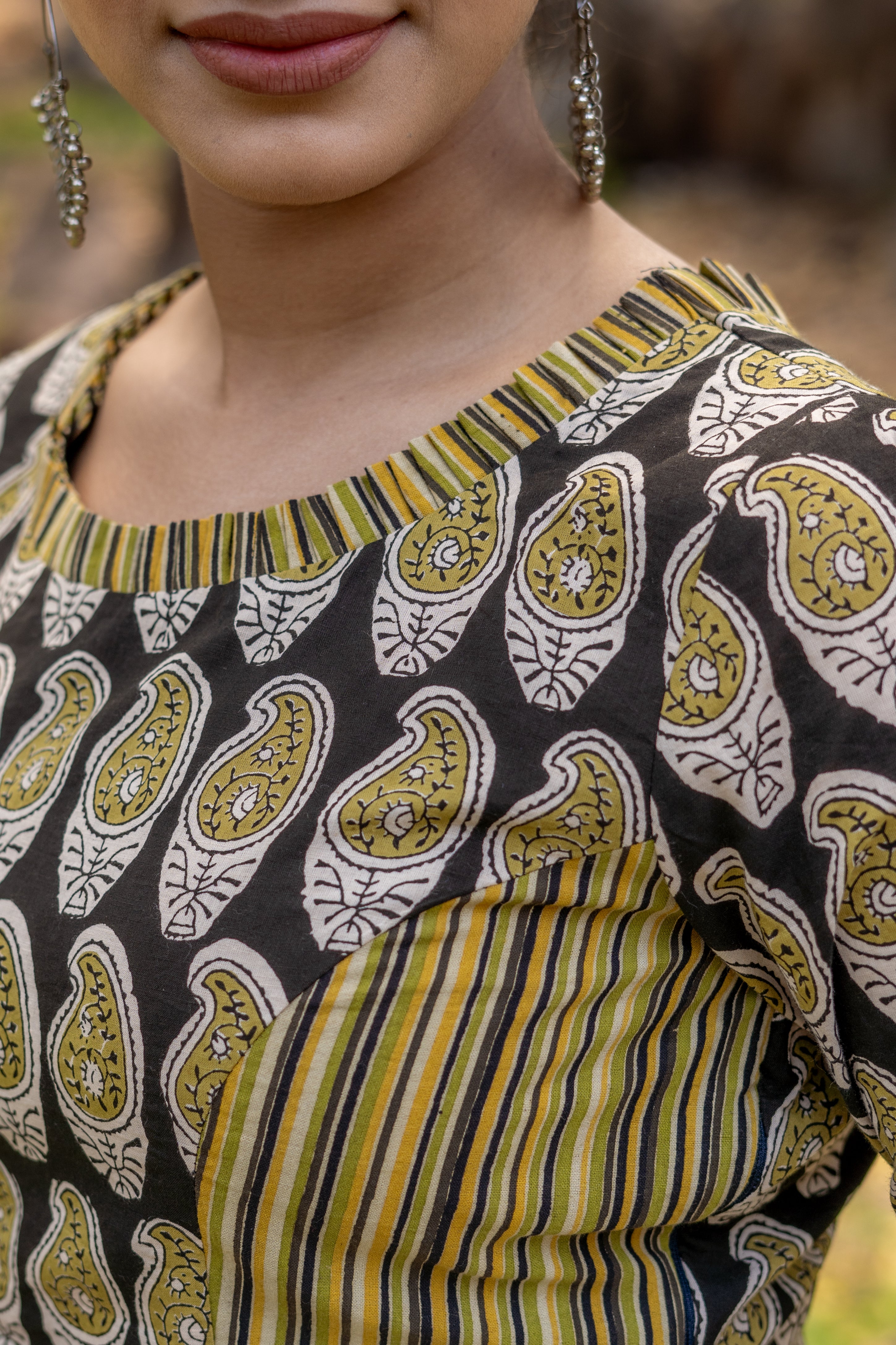 Olive and black handblock paisley print round neck cotton blouse with frills on neck and sleeves